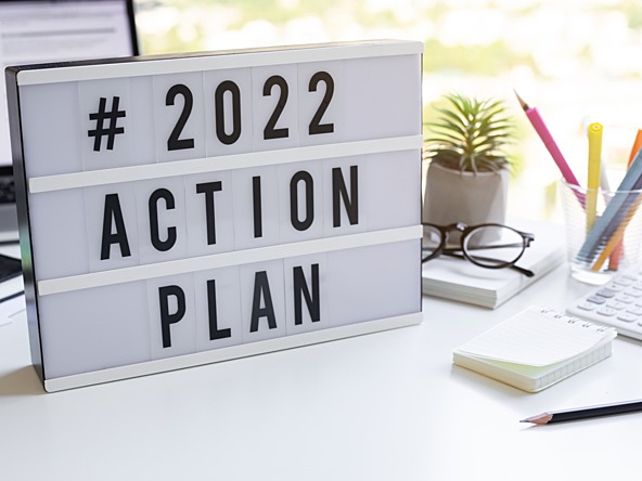 '2022 action plan' sign on desk'2022 action plan' sign on desk